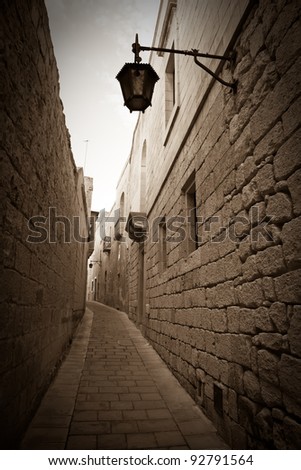 Retro photo of Old narrow town street of Mdina. Malta