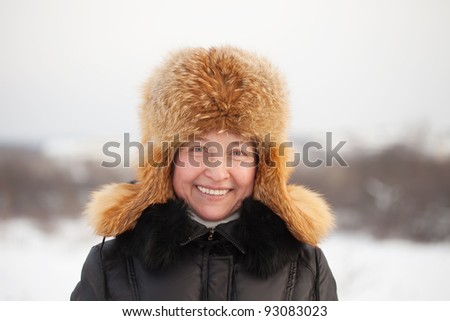 mature woman  wearing winter coat and fur  cap