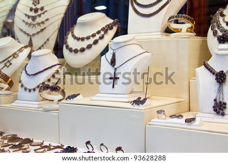 counter with garnet jewelry in store window