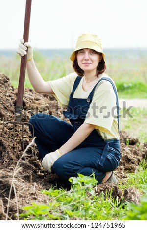 farmer works with manure at farm