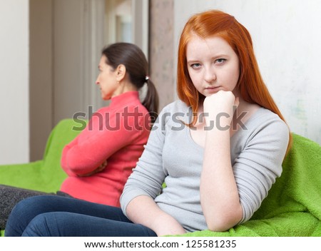 Mother and teen daughter having quarrel at home. Focus on girl
