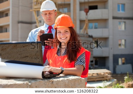 White-collar workers wearing protective helmet works on the building site