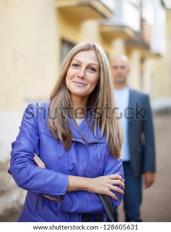 Man walks behind woman on the city street