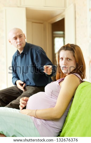 pregnant couple after quarrel in home interior