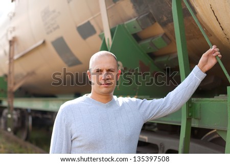 worker near cistern car  at railway