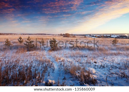 Rural wintry landscape in sunrise