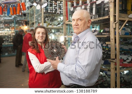 mature man and woman with  clutch  in  auto parts store