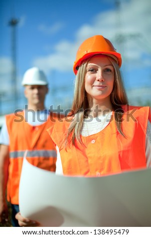two workers wearing protective helmet works at electrical power station two workers wearing protective helmet works at electrical power station