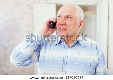 Portrait of  mature man speaks by phone