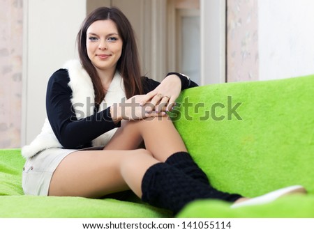 Portrait of brunette woman in leg warmers at home