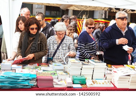 BARCELONA, SPAIN - APRIL 23: Books on street stalls  in Saint George day in April 23, 2013 in Barcelona, Spain. Saint George is the patron saint of city, Ã?Â¢??Ã?Â¢??decided to give red roses and books