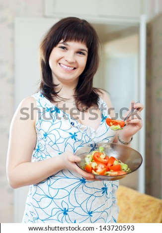 positive  ordinary woman plate of  tomatoes salad at home
