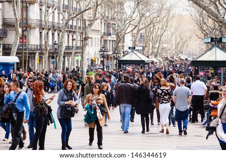 Barcelona, Spain - March 28: Walking People At La Rambla In March 28, 2013 In Barcelona, Spain. La Rambla One Of Symbol Of City. Center Of Touristic Life