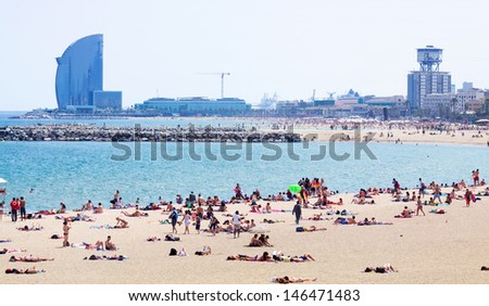 BARCELONA, SPAIN - JUNE 28: View of Nova Icaria beach in summer in June 28, 2013 in Barcelona, Spain.  One of the beaches of the Mediterranean coast