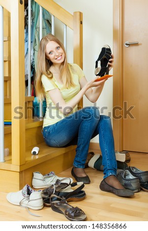 Long-haired  woman cleaning footwear at home