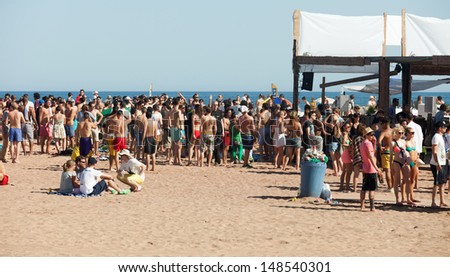 BARCELONA, SPAIN - JUNE 16: Party on Sant Adria beach in June 16, 2013 in Barcelona, Spain.  Mediterranean coast in Catalonia has beaches with entertainment to suit all tastes