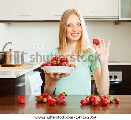 blonde long-haired girl with strawberries