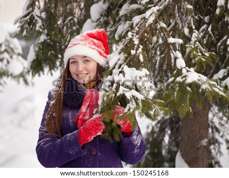 Portrait of  woman near fir-tree in winter