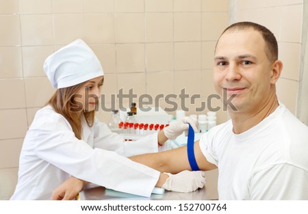 Positive nurse prepares to make an intravenous injection. Focus on man