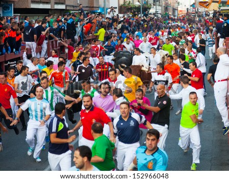 SAN SEBASTIAN DE LOS REYES, SPAIN - AUGUST 30: Encierro - Running of the Bulls in August 30, 2013 in San Sebastian de los Reyes, Spain. The race is known as 