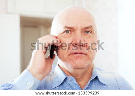 calm mature man speaks by phone