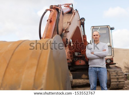 Portrait of tractor operator at sand pit