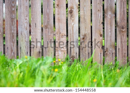 wooden fence background with green grass border