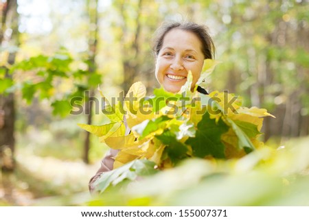 Portrait of  laughing mature woman  in autumn park