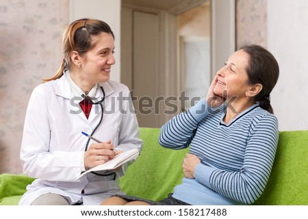 Friendly doctor asked happy female mature patient feels at hospital