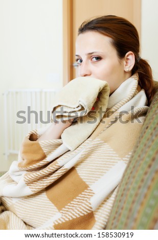 illness woman in warm plaid with handkerchief