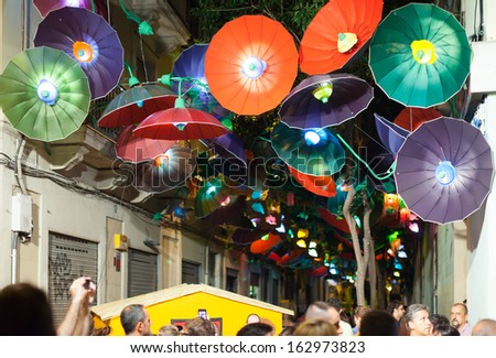 BARCELONA, CATALONIA - AUGUST 15: Festa Major de Gracia in night in August 15, 2013 in Barcelona, Catalonia. Decorated streets of Gracia district. Umbrellas theme