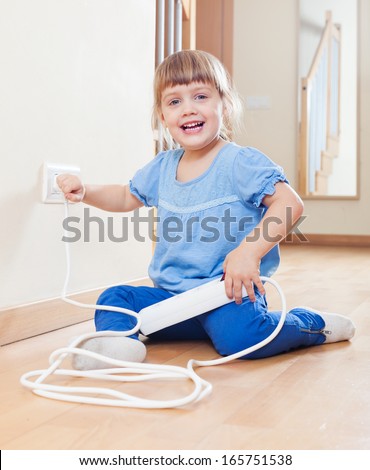 three year old child playing with electricity