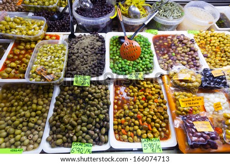 Various marinated olives in cans at Spanish market