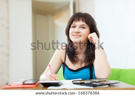 serious casual girl with money and documents  in home interior