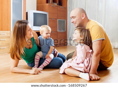 Happy family of four in home