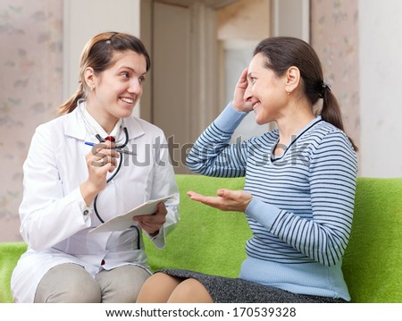 Friendly doctor asked happy female patient feels at hospital