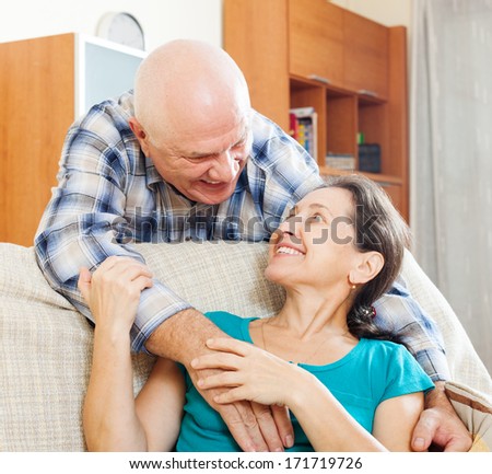 Happy mature man with beloved wife in home