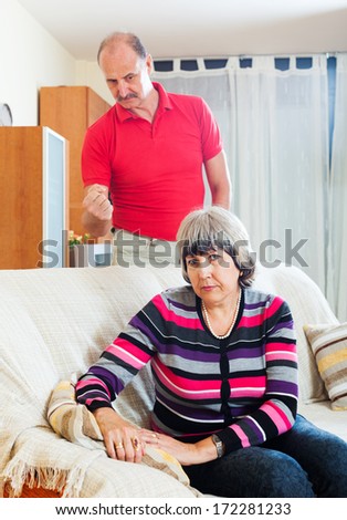 Family quarrel. Mature woman having problems with her husband at home