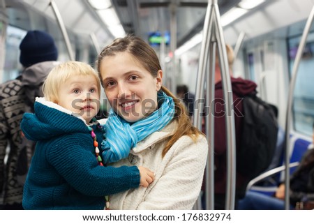mother with baby in subway train at metro