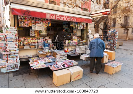 BARCELONA, SPAIN - FEBRUARY 20, 2014: News stands in Spain. Outdoor stands with newspapers and magazines at city street