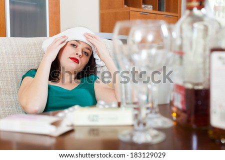 Young woman having headache in morning after party