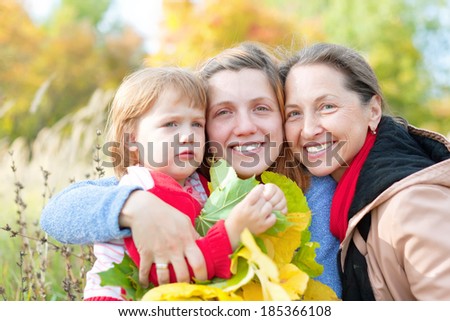 Portrait of three generations women in the autumn park