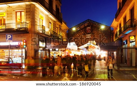 BARCELONA, SPAIN - MARCH 13, 2014: Night view of main gate at La Boqueria market in Barcelona.  Market has been known since 1217. Now - one of the city\'s foremost tourist landmarks