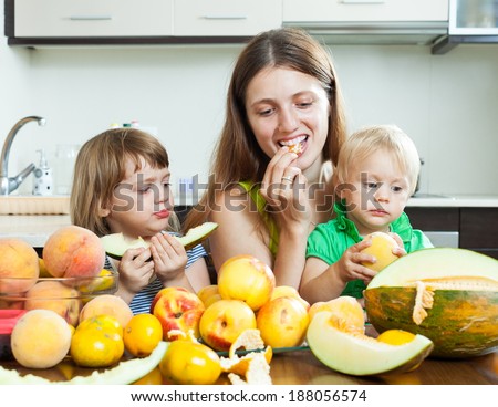 Ordinary family eating melon and other fruits at home