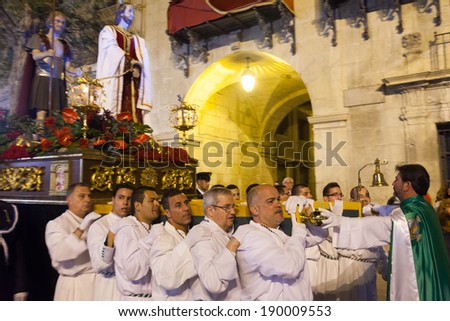 ALICANTE, SPAIN - APRIL 14, 2014: Night procession during Holy Week in Spain. Holy Week is  annual commemoration  by Catholic religious brotherhoods, processions on  streets of Spanish city and town