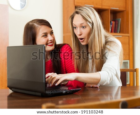 wonder women looking to laptop at table in home or office