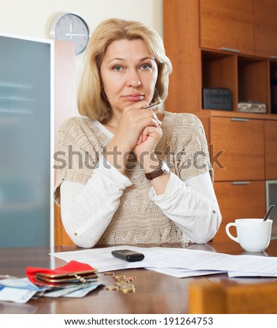 Serious woman thinking about the financial issue at  home