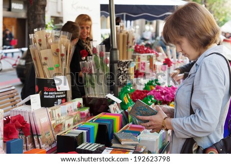 BARCELONA, SPAIN - APRIL 23, 2014: Sant Jordi feast - Catalan Saint George day in Catalonia, Spain. Books and red roses is traditionally gifts of festival