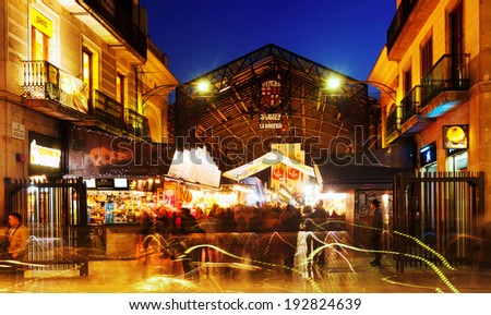 BARCELONA, SPAIN - MARCH 13, 2014: Evening of main gate at La Boqueria market in Barcelona.  Market has been known since 1217. Now - one of the city\'s foremost tourist landmarks