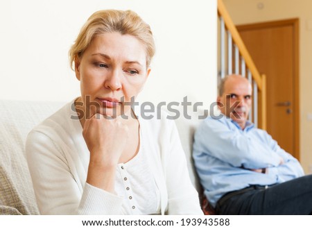 Sad  man and  woman during quarrel  in room at home